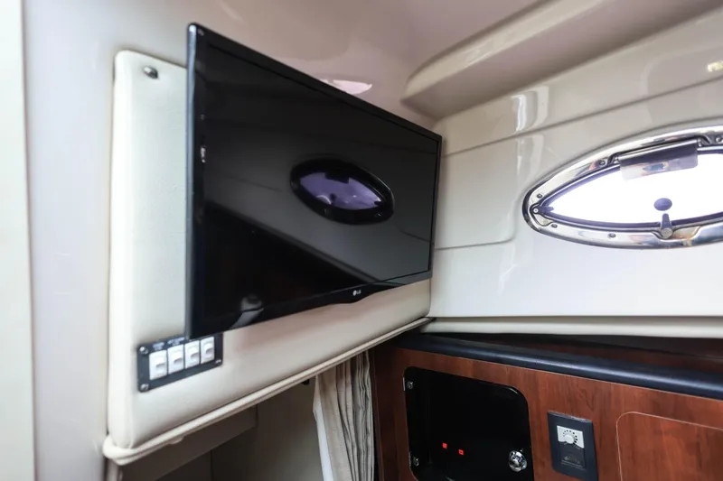 Slide: The Image of Interior of 2018 Robalo R305 Walkaround featuring a mounted TV and porthole window. - 34
