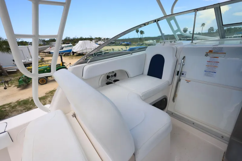 Slide: The Image of 2018 Robalo R305 Walkaround boat interior with white seating and outdoor view. - 23