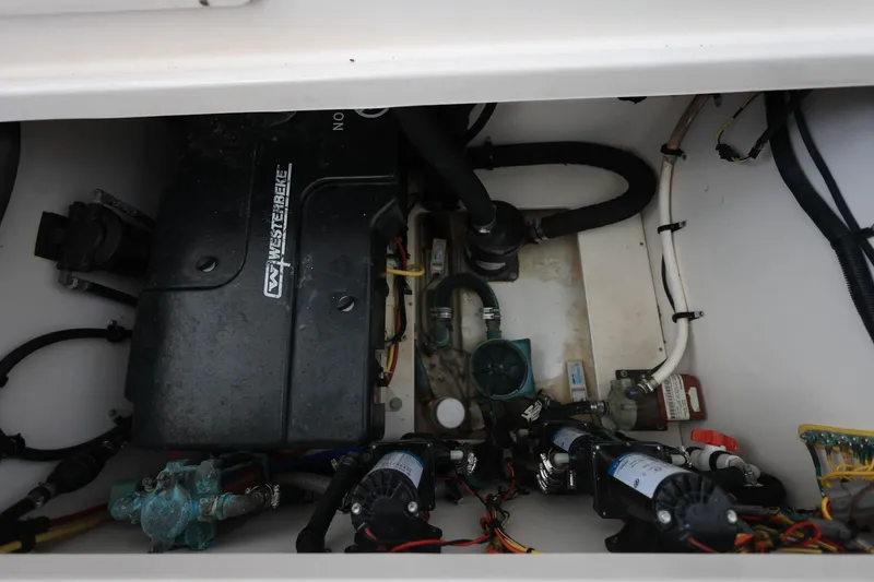 Slide: The Image of Engine compartment of 2018 Robalo R305 Walkaround boat, featuring mechanical components and wiring. - 15