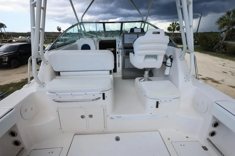 Slide: The Image of 2018 Robalo R305 Walkaround boat interior with white seating and helm station. - 13
