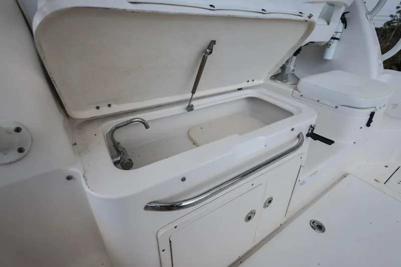 Slide: The Image of 2018 Robalo R305 Walkaround boat sink and storage area. - 17