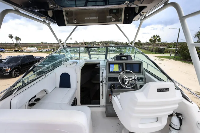 Slide: The Image of 2018 Robalo R305 Walkaround boat interior with helm, seating, and navigation equipment. - 19