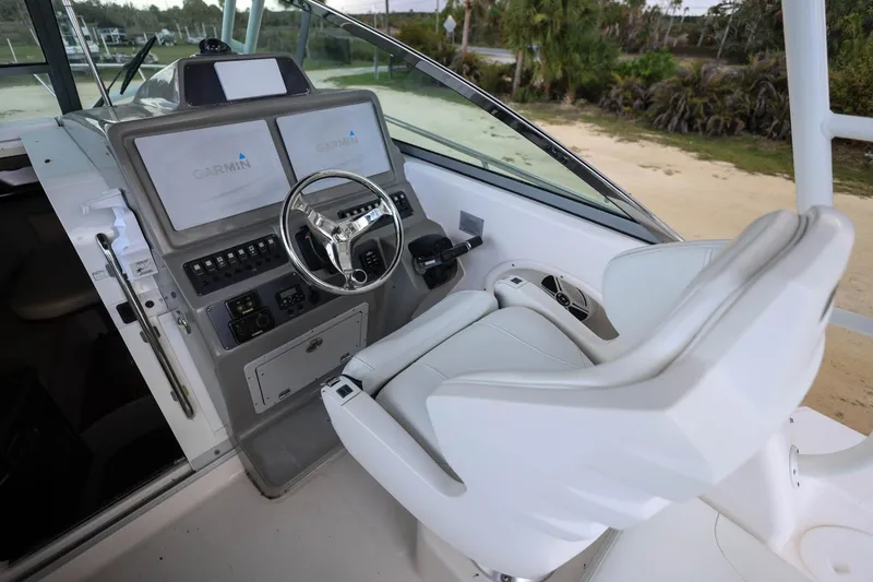 Slide: The Image of 2018 Robalo R305 Walkaround helm with Garmin displays and comfortable captain's chair. - 20