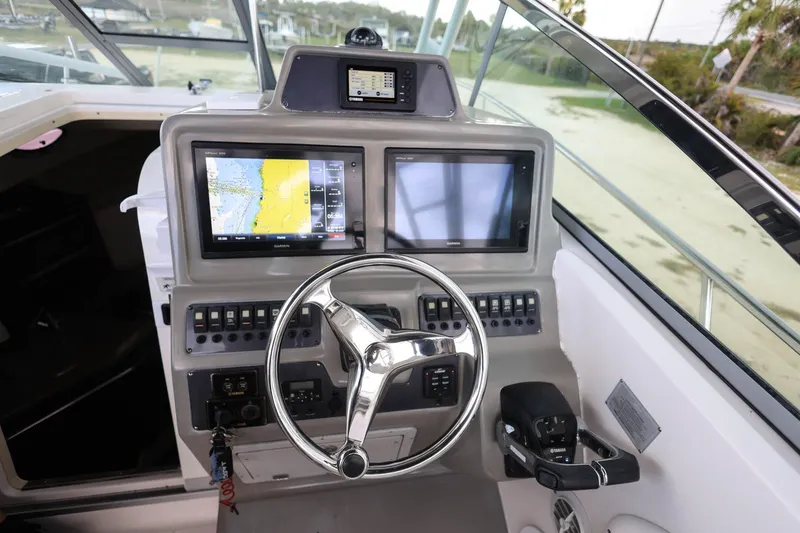 Slide: The Image of 2018 Robalo R305 Walkaround helm with dual displays and modern controls. - 21