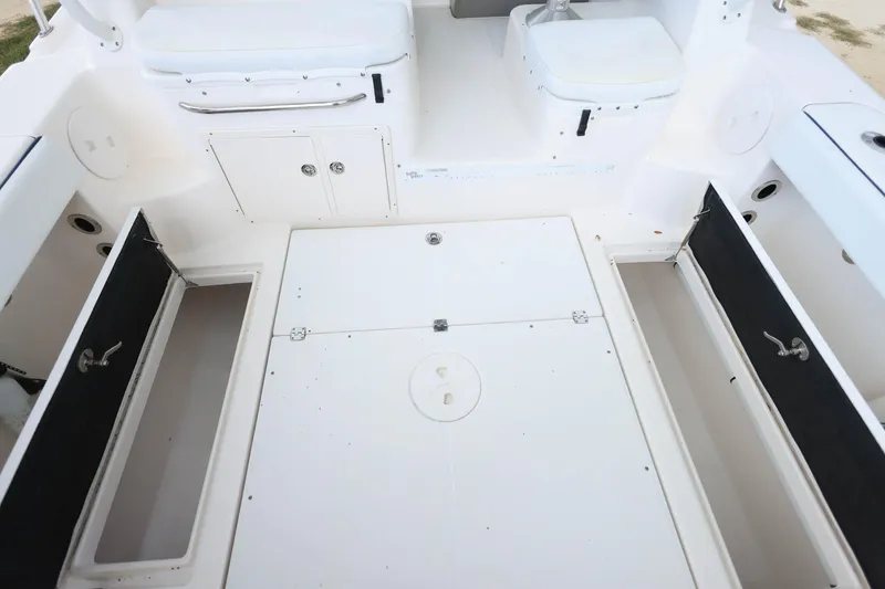 Slide: The Image of 2018 Robalo R305 Walkaround boat deck with open storage compartments. - 14