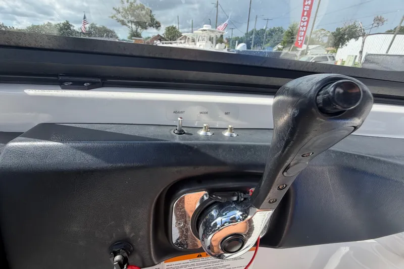 Slide: The Image of Close-up of 2018 Scarab 195 G boat throttle control with adjustment switches. - 28
