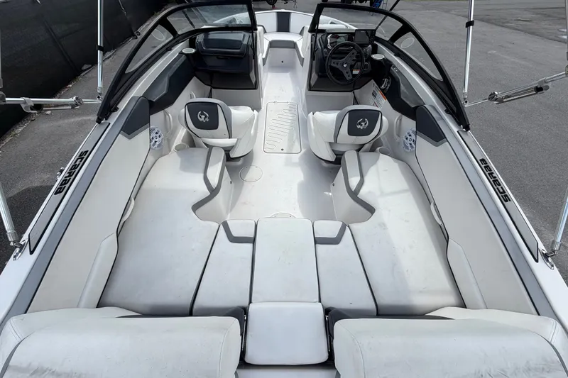 Slide: The Image of Interior view of a 2018 Scarab 195 G boat, featuring sleek seating and modern design. - 13