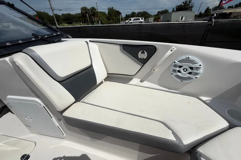 Slide: The Image of Interior seating of a 2018 Scarab 195 G boat with speaker and storage compartment. - 42