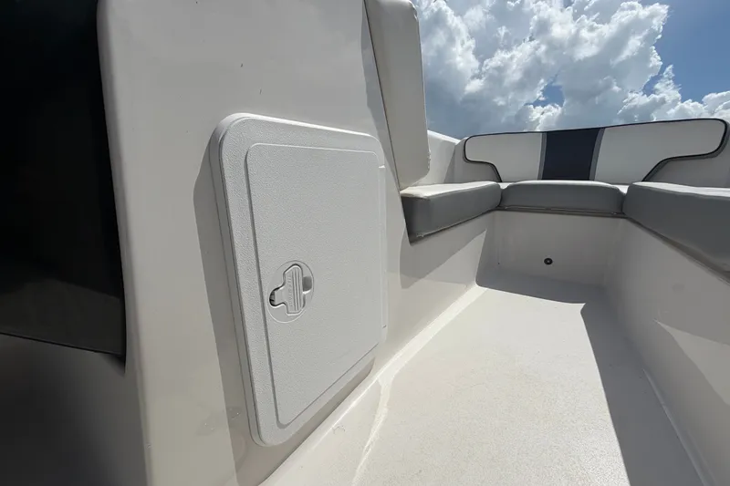 Slide: The Image of 2018 Scarab 195 G boat interior with seating and storage compartment under a cloudy sky. - 35