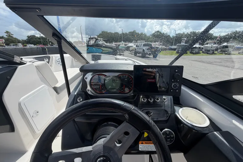 Slide: The Image of Cockpit view of a 2018 Scarab 195 G boat with dashboard and controls. - 22
