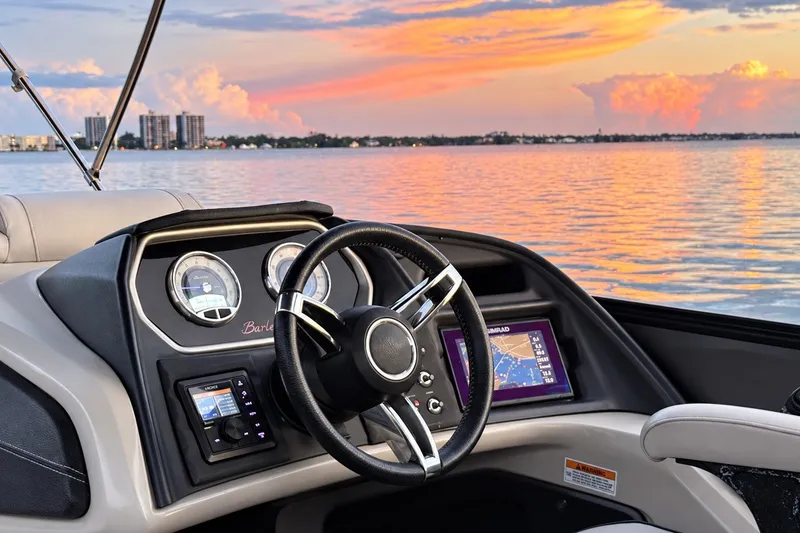 Slide: The Image of 2020 Barletta L-CLASS L25QCSSA boat dashboard with sunset view over water. - 22