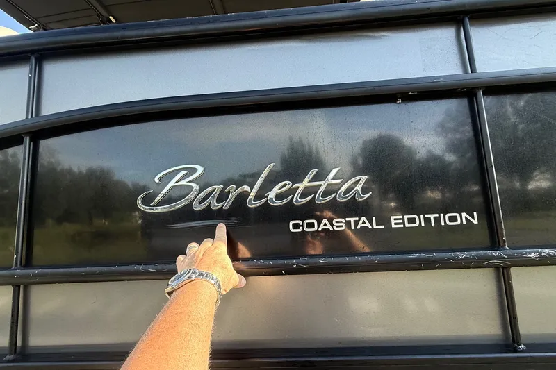 Slide: The Image of 2020 Barletta L-Class L25QCSSA Coastal Edition boat with hand pointing at logo. - 36