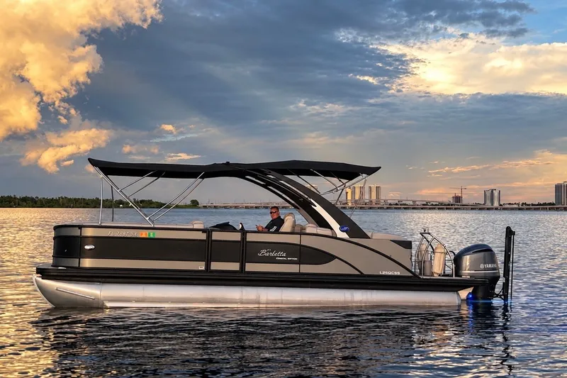 Slide: The Image of 2020 Barletta L-CLASS L25QCSSA pontoon boat on calm water at sunset. - 14