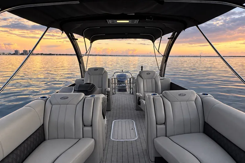 Slide: The Image of 2020 Barletta L-Class L25QCSSA Coastal Edition boat interior at sunset on calm water. - 26
