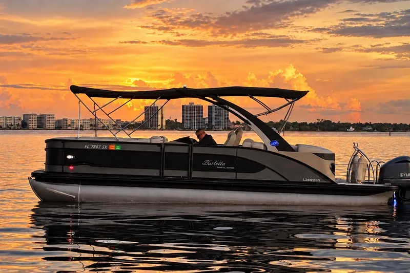 Slide: The Image of 2020 Barletta L-Class L25QCSSA pontoon boat at sunset on calm water. - 16