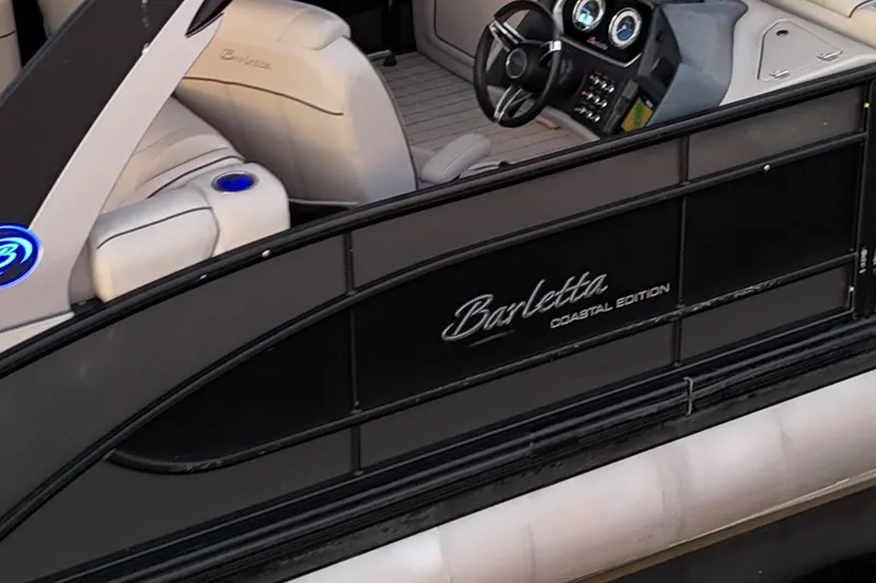 Slide: The Image of 2020 Barletta L-CLASS L25QCSSA Coastal Edition boat interior with steering wheel and seating. - 34