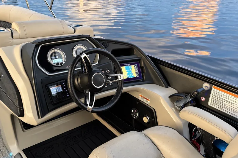 Slide: The Image of 2020 Barletta L-CLASS L25QCSSA boat dashboard with steering wheel and navigation display. - 21
