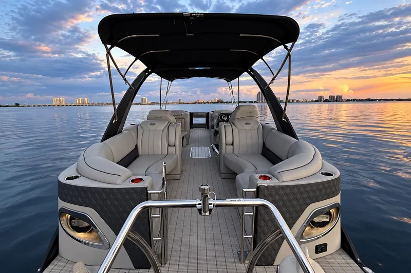 Slide: The Image of 2020 Barletta L-CLASS L25QCSSA boat on calm water at sunset. - 25