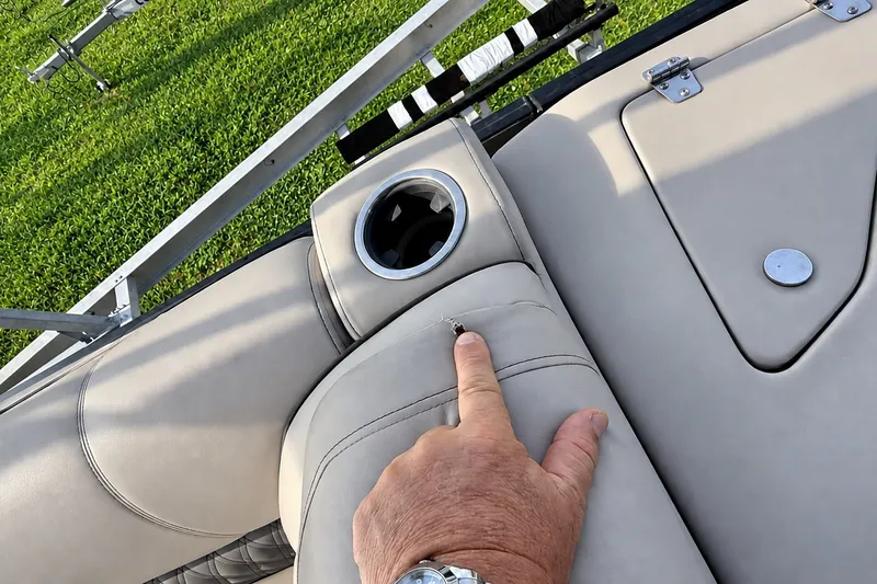 Slide: The Image of Hand pointing at a tear on Barletta L-CLASS L25QCSSA boat seat, 2020 model. - 47