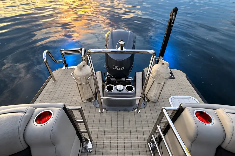 Slide: The Image of 2020 Barletta L-CLASS L25QCSSA boat deck with motor, sunset reflection on water. - 13