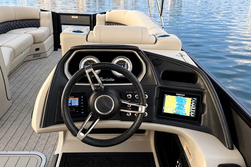 Slide: The Image of 2020 Barletta L-Class L25QCSSA boat dashboard with steering wheel and navigation screens. - 20