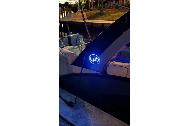 Slide: The Image of 2020 Barletta L-CLASS L25QCSSA boat with illuminated logo at dockside. - 32