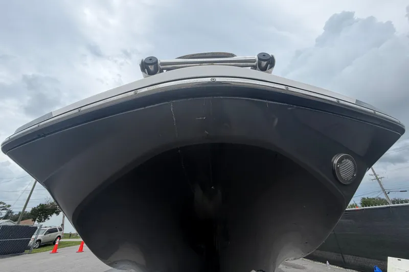 Slide: The Image of 2018 Scarab 255 ID boat, front view, under cloudy sky. - 9