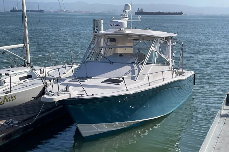 Slide: The Image of 2003 Grady-White Express 330 boat docked in calm waters. - 2