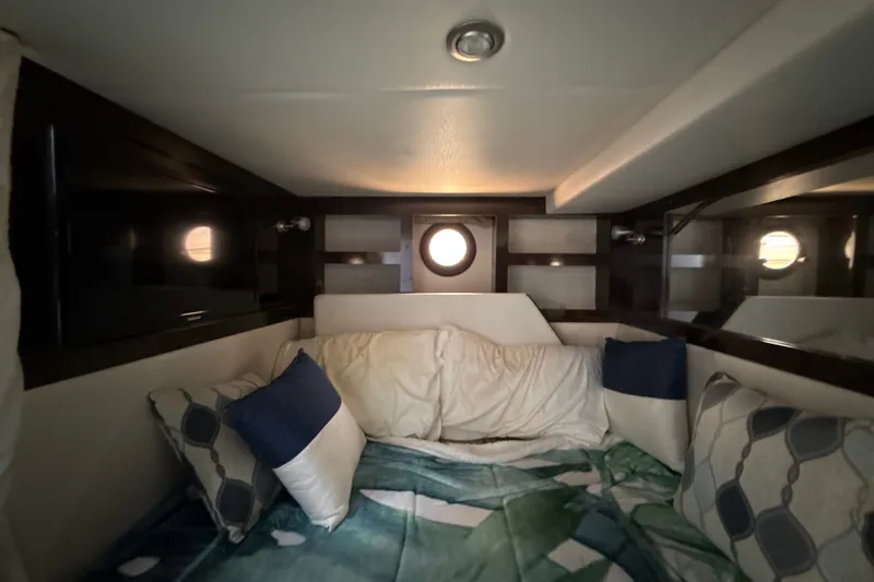 Slide: The Image of Cozy cabin interior of 2018 Sea Ray Sundancer 350 Coupe with pillows and porthole. - 68