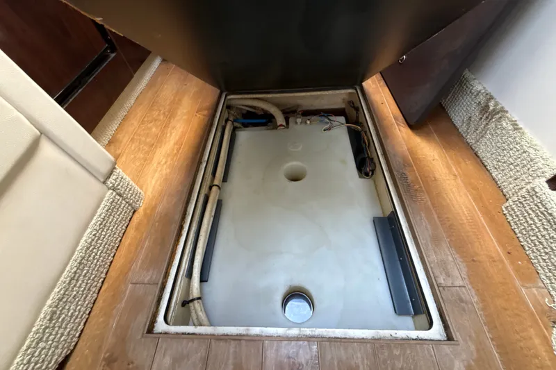 Slide: The Image of 2018 Sea Ray Sundancer 350 Coupe interior compartment with wooden flooring and storage access. - 59