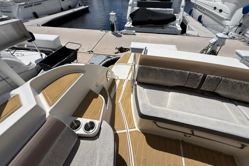 Slide: The Image of 2018 Sea Ray Sundancer 350 Coupe yacht interior with seating and cup holders at marina. - 93