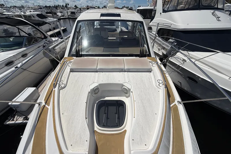 Slide: The Image of 2018 Sea Ray Sundancer 350 Coupe docked among other boats at a marina. - 111