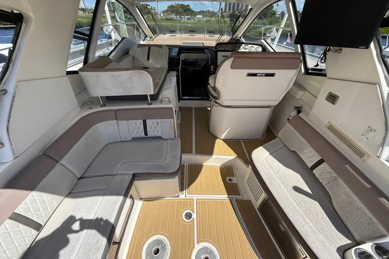 Slide: The Image of Interior of 2018 Sea Ray Sundancer 350 Coupe with luxurious seating and modern helm. - 19