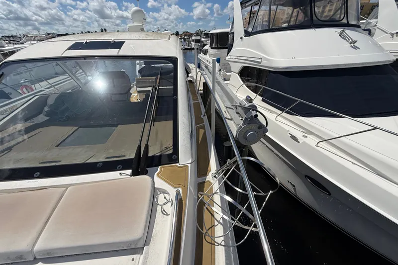 Slide: The Image of 2018 Sea Ray Sundancer 350 Coupe docked beside another yacht under a sunny sky. - 115