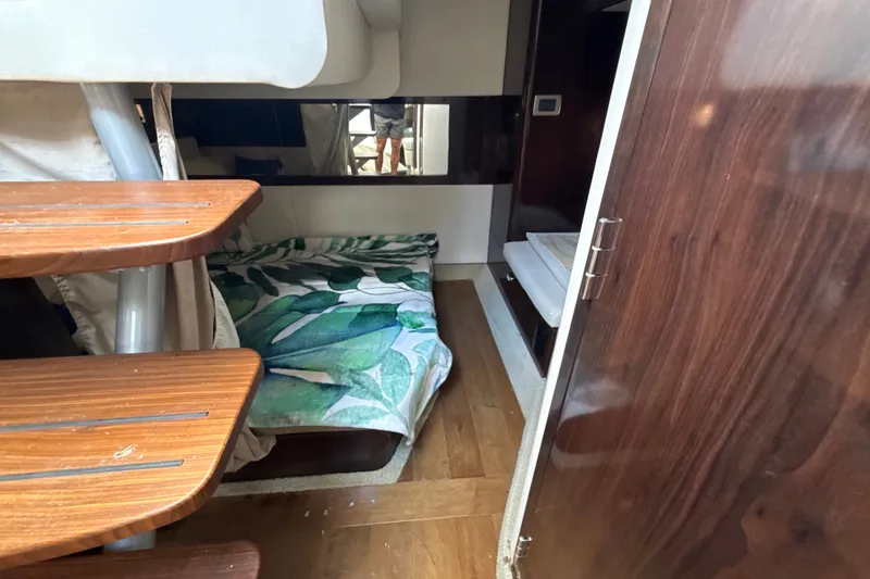 Slide: The Image of Interior cabin of 2018 Sea Ray Sundancer 350 Coupe with wooden steps and tropical bedding. - 65