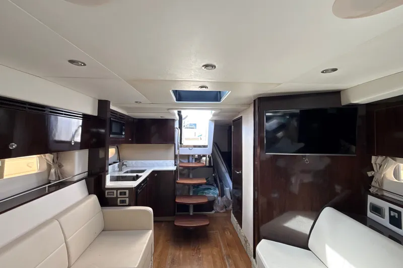 Slide: The Image of Interior of 2018 Sea Ray Sundancer 350 Coupe with modern furnishings and wooden accents. - 57