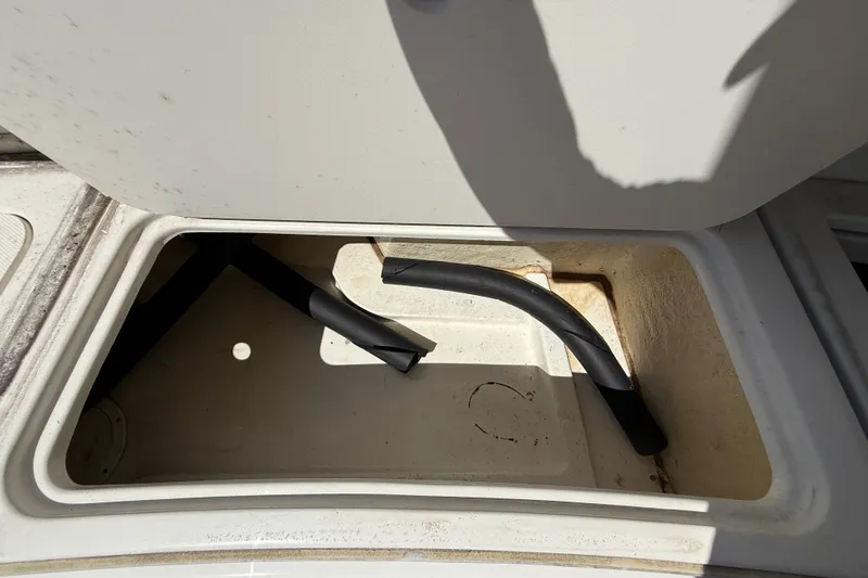 Slide: The Image of Storage compartment of 2018 Sea Ray Sundancer 350 Coupe with black hoses inside. - 84