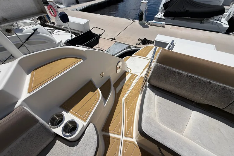 Slide: The Image of 2018 Sea Ray Sundancer 350 Coupe interior with seating and cup holders at dock. - 97