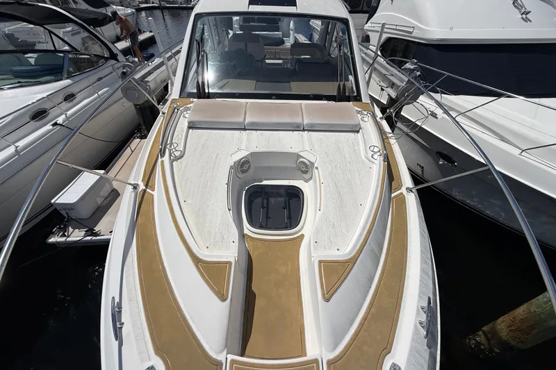 Slide: The Image of 2018 Sea Ray Sundancer 350 Coupe docked, showcasing sleek design and spacious deck. - 110