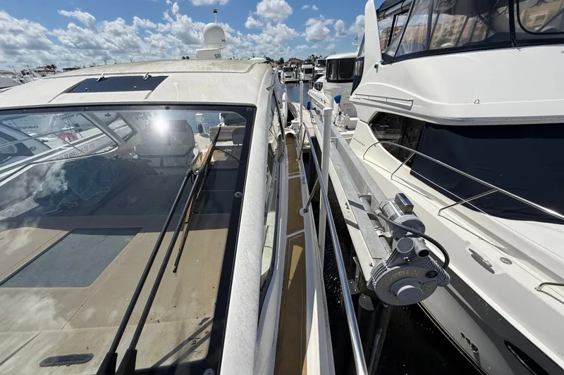 Slide: The Image of 2018 Sea Ray Sundancer 350 Coupe docked alongside other boats under a sunny sky. - 116