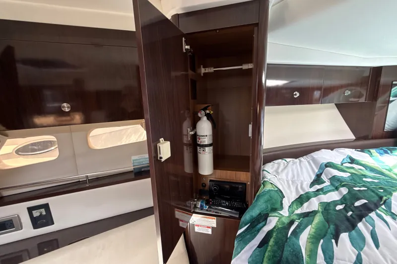Slide: The Image of Interior of 2018 Sea Ray Sundancer 350 Coupe with fire extinguisher and storage cabinet. - 49