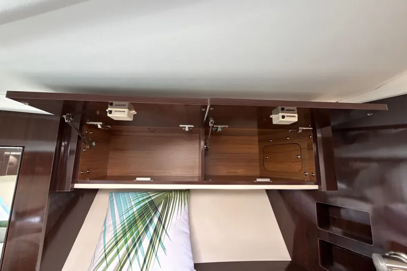 Slide: The Image of Open wooden cabinet inside 2018 Sea Ray Sundancer 350 Coupe yacht interior. - 55