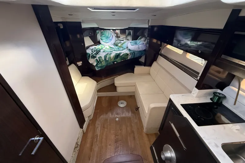 Slide: The Image of Interior of 2018 Sea Ray Sundancer 350 Coupe with modern seating and cozy sleeping area. - 33