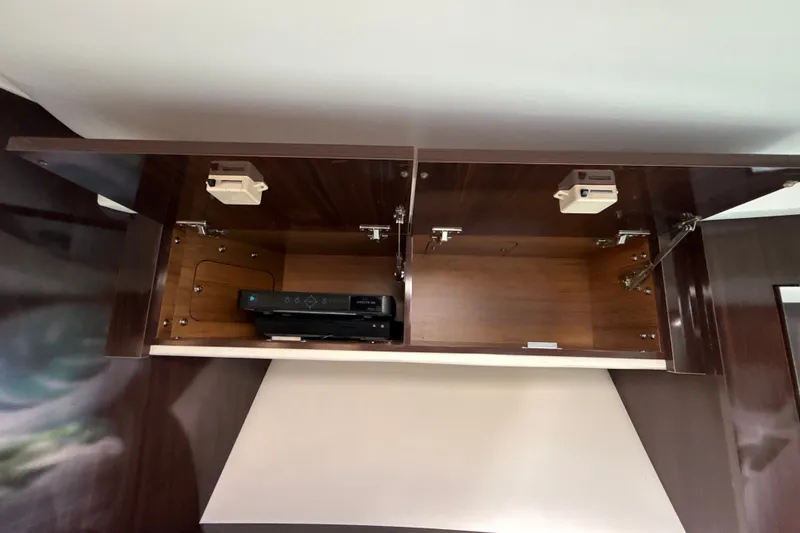 Slide: The Image of Open cabinet in 2018 Sea Ray Sundancer 350 Coupe with electronic device inside. - 56