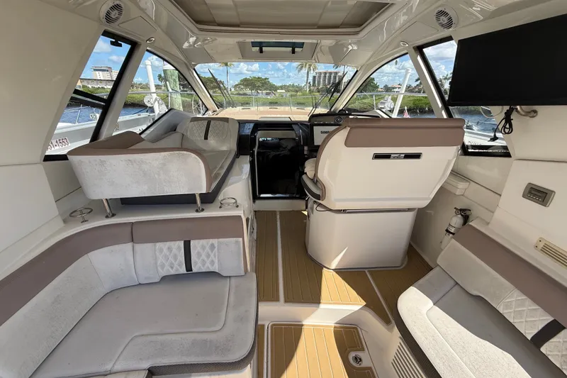 Slide: The Image of Interior of 2018 Sea Ray Sundancer 350 Coupe with luxurious seating and helm. - 20