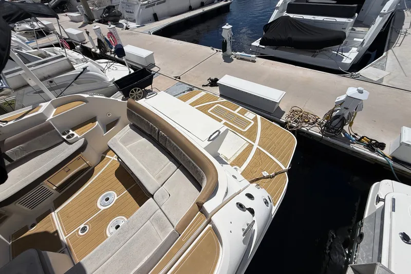 Slide: The Image of 2018 Sea Ray Sundancer 350 Coupe docked, showcasing spacious deck and seating area. - 122