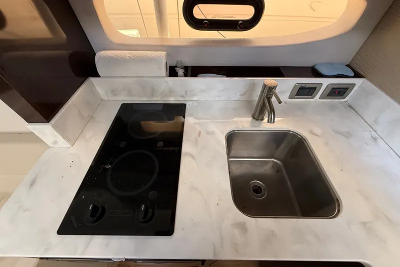 Slide: The Image of Modern kitchen area in 2018 Sea Ray Sundancer 350 Coupe with stove and sink. - 37
