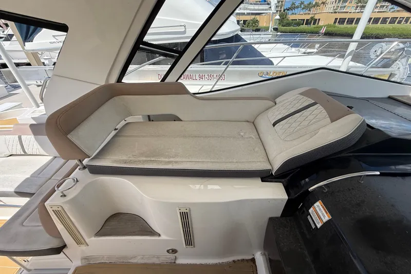 Slide: The Image of 2018 Sea Ray Sundancer 350 Coupe interior seating area on a luxury yacht. - 77