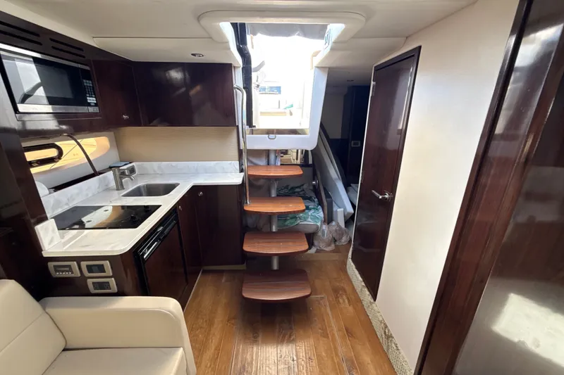 Slide: The Image of Luxurious interior of 2018 Sea Ray Sundancer 350 Coupe with modern kitchen and wooden stairs. - 60