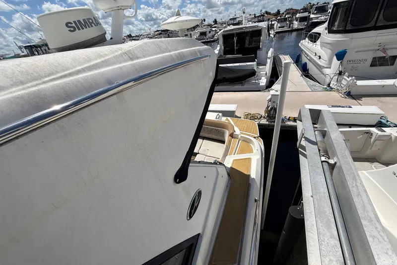 Slide: The Image of 2018 Sea Ray Sundancer 350 Coupe docked at a marina under a sunny sky. - 120